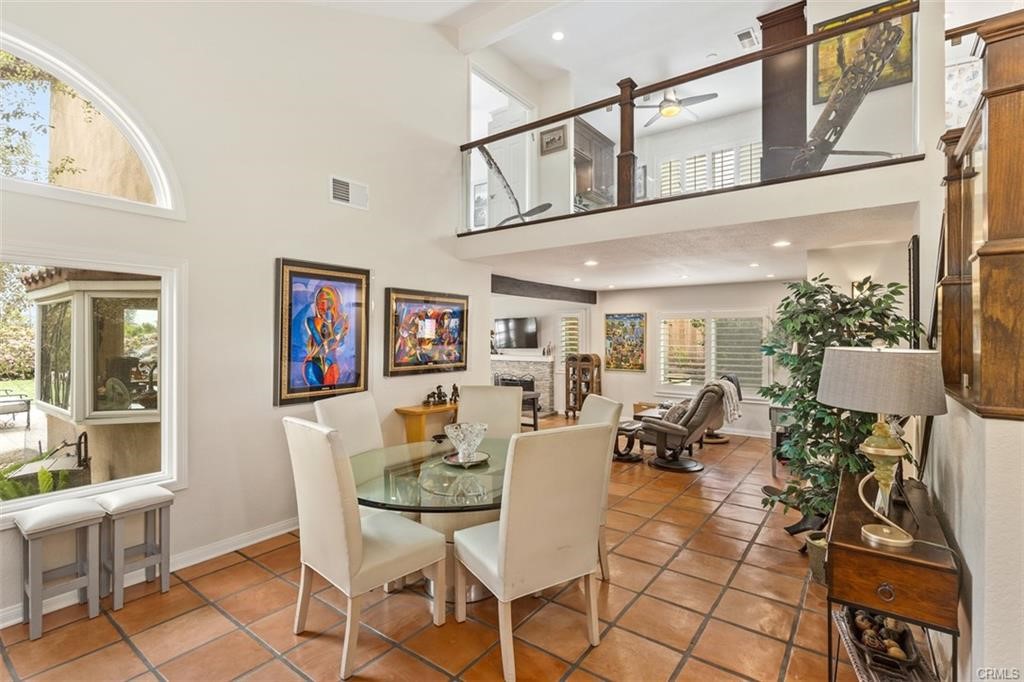 Formal living room has tall ceilings, custom Saltillo tile, open feel that is bright and airy with custom stairwell.