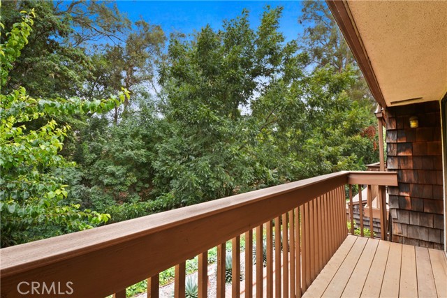 Primary Bedroom suite opens to newly replaced balcony, ideal for quiet relaxation and peaceful tree views
