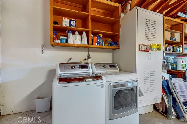 Laundry hookups and water heater in the garage. Garage has ample built in shelves