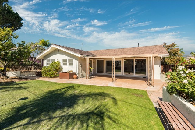 Tranquil backyard with shaded patio off the living room.  Perfect extension of the inside to the outside entertaining.