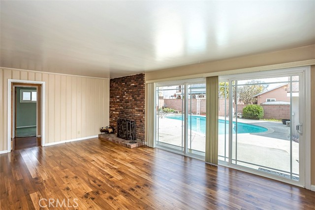 Living room has fireplace and view of yard