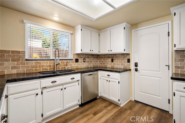The kitchen boasts granite countertops and a custom tile backsplash.