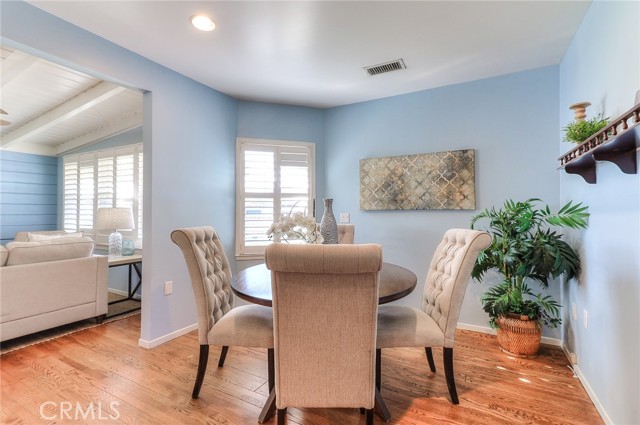 Eating area in the kitchen, beautiful wood floors.