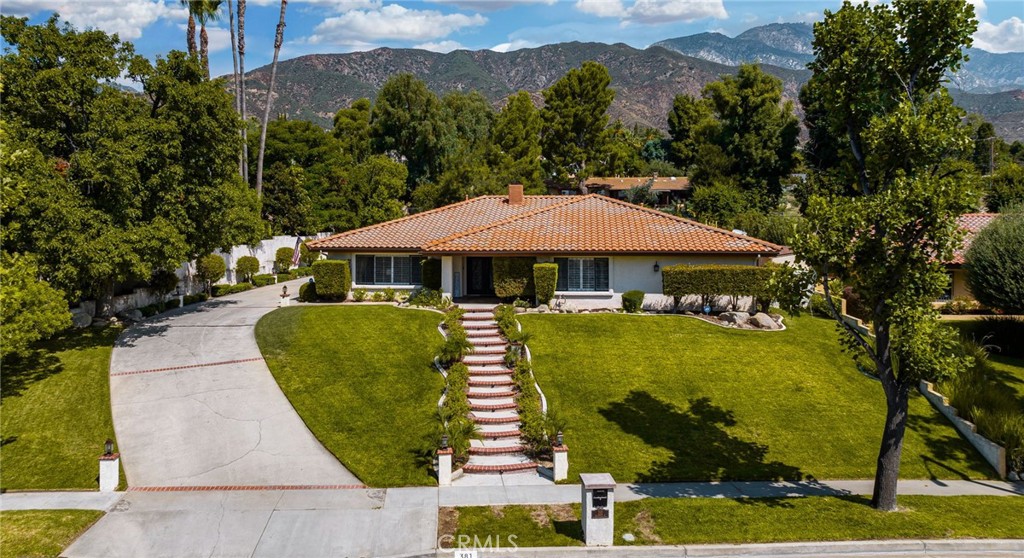 Welcome to 381 Browning Street - Gorgeous Custom Built "Nick Gula Design" single story turnkey home! An exquisite property perfectly situated at the base of the stunning San Gabriel Mountains. This highly desirable location sets the stage for luxurious living in a single-story residence spanning over 3700 sq. ft. Step into the grandeur of 4 bedrooms and 3 bathrooms, all flawlessly designed for comfort and elegance. The layout features a formal living room and dining room, both tastefully appointed to host gatherings in style. The heart of the home lies in the expansive family room, seamlessly connecting to the kitchen. A fireplace, adorned with floor-to-ceiling stacked stone, creates a cozy focal point. Adjacent is your personal wet bar, a space to unwind and entertain with ease. As you explore, you'll appreciate the meticulous details throughout. Gorgeous travertine floors and granite countertops grace every corner, while plantation shutters lend an air of sophistication. The double-door entry, embellished with iron and glass, sets the tone for memorable entertainment. For culinary enthusiasts, an upgraded kitchen awaits, as well as remodeled bathrooms throughout the home. The primary en suite is a true retreat, boasting a generous walk-in closet, remodeled bathroom with double sinks, a vanity area, walk-in shower, and a luxurious soaking tub. 3 additional bedrooms offer versatility and space for personalization, whether for work or play. A spacious indoor laundry room with cabinetry and sink enhances convenience. Step outdoors, and you'll discover your own private oasis sprawling over a lot size of over 20,000 sq. ft. The backyard is designed for entertainment, featuring a custom vaulted patio cover – ideal for gatherings and watching sporting events on the big screen. Enjoy a built-in fireplace as you take in the captivating views. The jewel of the backyard is an upgraded pool and spa, accompanied by kiddie pools and fire features. A separate fire ring with built-in seating beckons you to create cherished memories while roasting marshmallows. A large lush grassy area invite relaxation and play. A private driveway leads to the 3 car garage, and the property offers the convenience of RV parking. Marvel at the backdrop of majestic mountains that grace the horizon. This home is the epitome of luxury, upgraded to perfection, and ready for you to move in and make it your own. You deserve to live the dream!