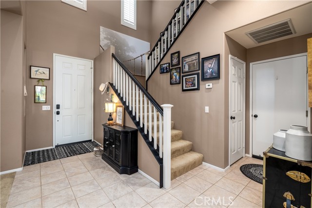 Walk thru the front door to high ceilings.