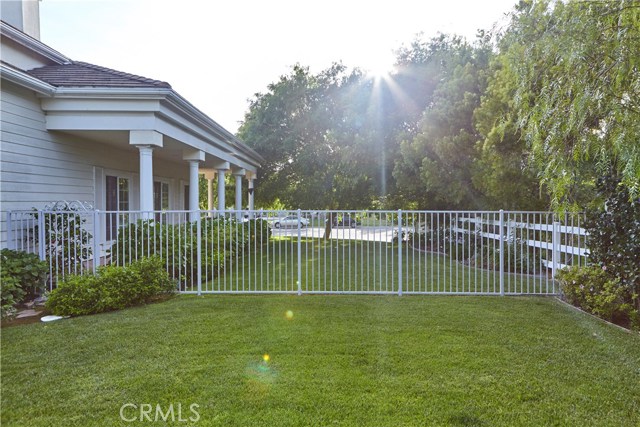 View of fencing separating back yard and front side yard