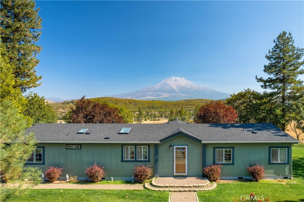2700 Shasta Valley Rd Weed, California This property has it all, beautiful views of Mt. Shasta & Black Butte. Surrounded by a beautiful, landscaped yard with an underground sprinkler system & shade trees. China Ditch runs through the property with water rights, a pond, field for grazing livestock & a horse shelter. This property sits on over 12 acres with a mix of trees & open spaces. Step into the bright & welcoming move in ready home, that is over 2000 sq ft. The open concept offers a family rm & living rm, open dining area & a large kitchen with stainless steel appliances & granite countertops. The home offers 4 bedrooms & 2 bathrooms. New carpet in all the bedrooms & living area with fresh interior paint in most of the home. Brand new roof & freshly painted deck. Step onto the back deck & entertain your guests under the large gazebo, & soak in all the natural beauty, & wildlife. Paved parking area, large pad cleared for extra parking or ready to be built on. The home has a backup generator, RV parking with hookups. Shed for extra storage & a huge 2000 sq ft shop 40’x50’. With 3 roll up doors. Shop is completely insulated, has a backup generator, heating, & bathroom. Wired with multiple 220 plugs that are 60amp.