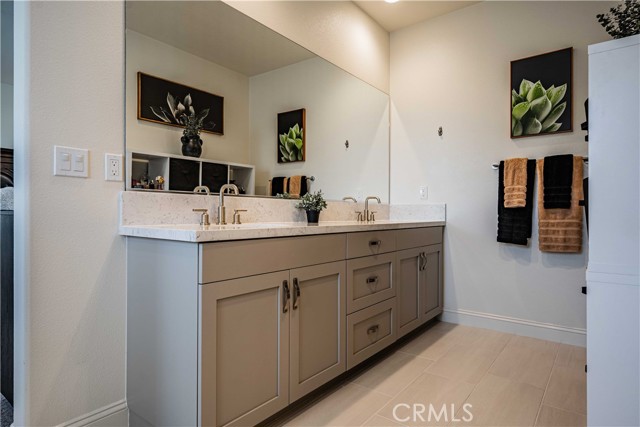 First primary bedroom en-suite bathroom is stunning with dolphin grey soft close cuboards, dual sinks with quartz contertops with the same stainless steel hardware.