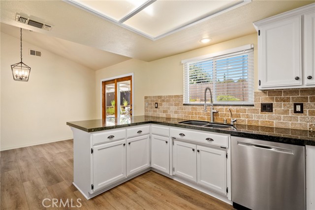 The window above the sink and sliding glass door in the dining area ushers in the natural light.