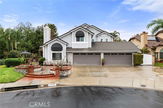 Nestled atop the hills in Yorba Linda at the end of a cul-de-sac, this spacious Brock home boasts a fabulous view of the city lights, hillsides, Disneyland fireworks and on a clear day a view of Catalina in the distance!!  It features a formal living room with fireplace and separate formal dining room, split staircase, dual pane windows, plantation shutters, recessed lighting and dual unit central air conditioning.  The updated kitchen with silestone counters and white cabinets opens to the family room with cozy fireplace, built-in TV unit and expansive windows encasing the sweeping views.  The downstairs bedroom and bath are perfect for those overnight guests.  The third fireplace warms the master bedroom suite and retreat...gain access to the walkout viewing deck with glass partitions through the sliding glass door.  Two additional bedrooms and one bathroom complete the upper story.  Relax on the patio with its retractable awning while enjoying the beauty of the lush landscaping and the sound of the bubbling in-ground spa...you've found your own little paradise!!  The four car garage is perfect for the car enthusiast.  The solar panels, which are purchased, will keep you cool on those summer evenings.  No HOA, freeway close, excellent Placentia/Yorba Linda School District.  Close proximity to parks and miles of walking trails.  Come buy!!