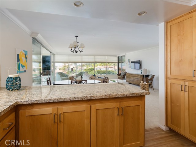 Kitchen view to dining area, living room, and views.