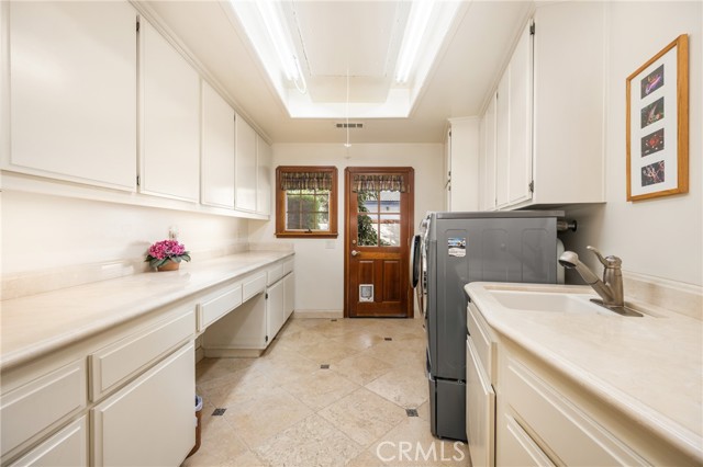 Spacious Laundry Room with Ample Storage and Utility Sink