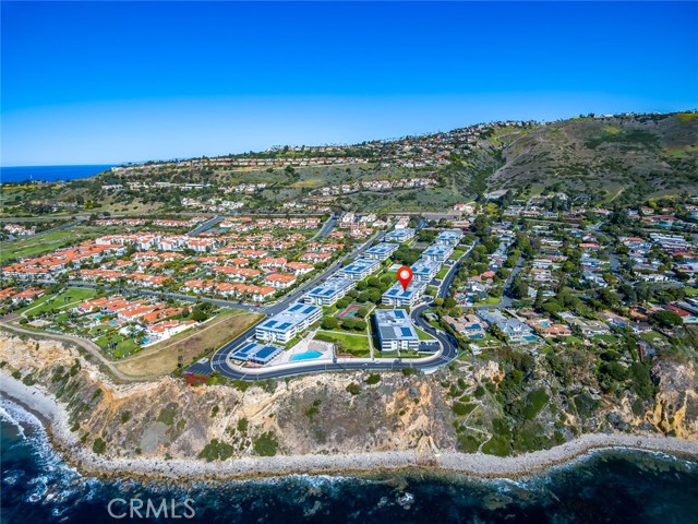 Aerial view of the entire complex and surrounding neighborhhood. Red pin shows location of the building where the property is located. Will you call this exceptional location home?