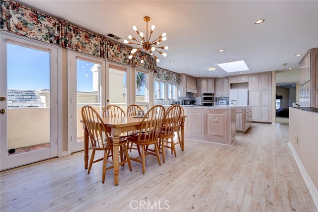 Family kitchen dining area with light wood style flooring