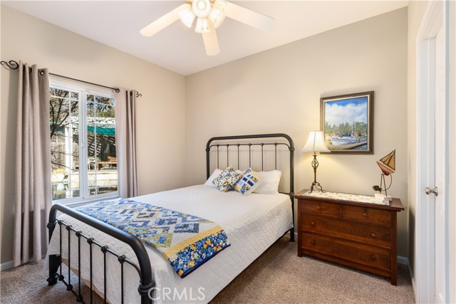 Bedroom with view of pool