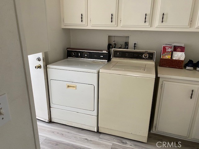 Laundry room with appliances and loads of storage.