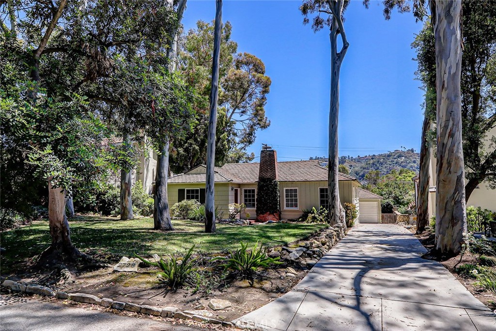Set back from the street and surrounded by mature eucalyptus trees, this storybook home offers the magic of lush Valmonte hill views, the neighborhood charm of The Grove, and classic Bungalow charm that you’ll fall in love with before you step inside. There’s nothing more inviting than the expansive front yard, ivy covered chimney and bright red front door to welcome you into 2728 Via La Selva. The living room greets you with beamed ceilings, a brick fireplace, warm wood floors and sunshine that pours in - this is the heart of the home. If you’re needing more living space, immediately off the living room through French doors is a den to set up a second couch and TV set up for a sports house divided or simply needing your own peace. If you’re up for a project, the den could be the perfect space to add a second bathroom and make a true primary suite. Large sliding doors open up to a large brick patio where you can set up your outdoor seating area and admire the massive green yard. Summer living is meant for this backyard. Original Bungalow charm shines in the dining room with quaint built-ins, plus direct access to the kitchen with stainless steel appliances & quartz countertops. Not to be missed is the proper laundry room with a countertop for folding (a dream come true), laundry sink and Dutch door that leads you to your private backyard. If you didn’t already love it, you’ll also find a bonus room perfect for an office off the garage. And of course the basics - 3 sizeable bedrooms, 1 bathroom, 1 car detached garage, very close distance to Malaga Cove, walking trails, the beach and above all that, it’s looking a lot like your next home. Welcome Home to Palos Verdes Estates!