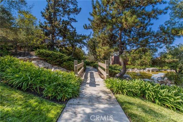 Bridge leads to a koi pond for tranquil strolls
