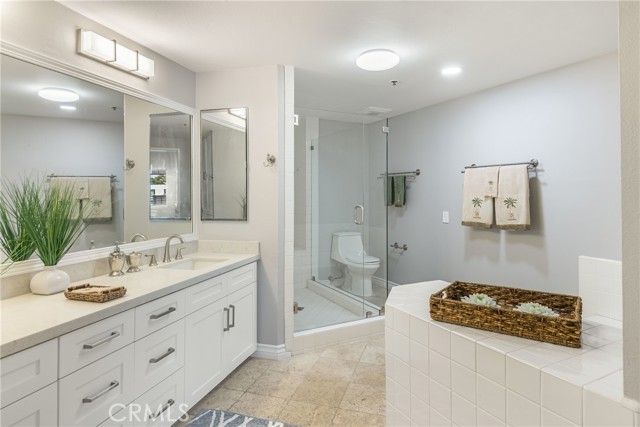 Amazing primary bathroom is huge for a 2 bedroom condo.  Enjoy frameless shower, dual vanities, new lighting, soaking tub and more