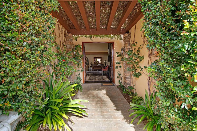 Lush greenery creates a romantic entrance into the main house.