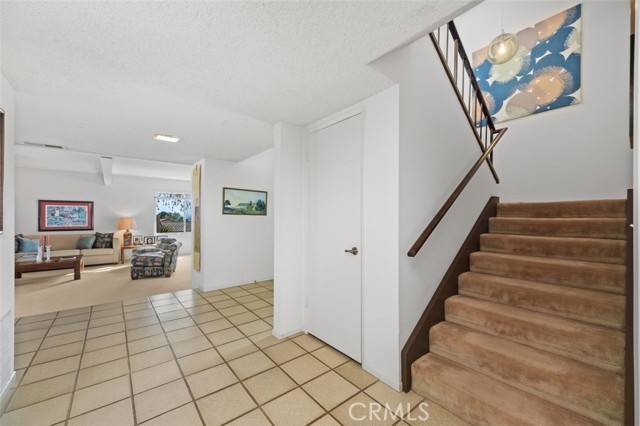 Formal living room opens to front entry hall and dining room, and toward kitchen/2nd living room.