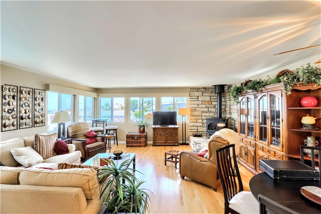 The Upper Floor Living Room Is Spacious and Surrounded by Bright Large Windows.