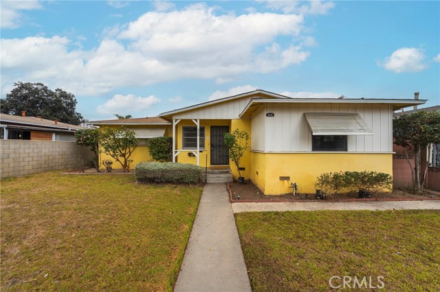 This inviting ranch-style home is ready for its new owners! With a spacious front yard, welcoming front porch, and a generous backyard with mature landscaping, this property offers both curb appeal and comfortable living. Step inside to discover fresh paint and new neutral laminate flooring throughout. The convenient family room overlooks the backyard, perfect for relaxing or entertaining. An inside laundry room adds to the functionality, and an attached two-car garage with additional parking in the rear provides ample space for vehicles. This home is bathed in natural light and offers a spacious, welcoming atmosphere. Plus, it's ideally located just a few blocks from vibrant downtown Anaheim, with easy access to Farmers Park and the Packing District. Don't miss out on this opportunity to own a move-in ready gem!