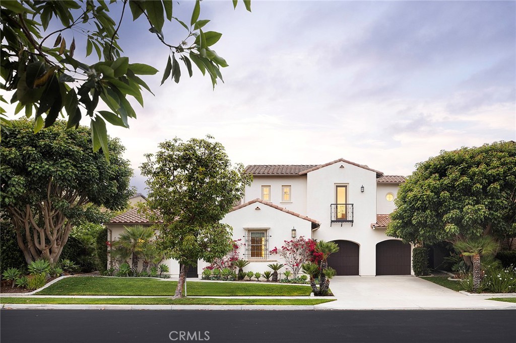 Poised on a quiet cul-de-sac in one of San Clemente’s most coveted neighborhoods, this exquisitely tailored Spanish estate in Alta at Talega offers a masterful blend of architectural grandeur and privacy. Behind a gated entry and manicured lawn—where a detached casita offers enhanced privacy just off the courtyard—the six-bedroom, six-and-one-half-bath residence unfolds across approximately 5,356 square feet, with a tranquil greenbelt backdrop that enhances its sense of seclusion. Inside, a soaring double-height foyer introduces a dramatic staircase of finely wrought iron and carved wood—a statement softened by bespoke finishes and curated light. Formal living and dining rooms feature Mediterranean detailing: wood-beamed ceilings, hand-troweled plaster walls, and a wine cellar with barrel ceiling, locking iron gate, and dual wine refrigerators for seamless entertaining. At the heart of the home, a luminous great room with stone-clad fireplace and media niche flows into a generous breakfast area and designer kitchen. Here, granite countertops, a center island, walk-in pantry, and custom butler’s pantry pair with top-tier Thermador and KitchenAid appliances, including a six-burner range, warming drawer, two new dishwashers, and built-in refrigerator. Furniture-quality cabinetry and refined materials like travertine flooring, high-end carpet, and luxury vinyl plank ground the living spaces. Arched passageways, French doors, and hand-selected lighting offer architectural continuity throughout. Owned solar panels with battery backup bring energy efficiency into elegant alignment. Accommodations include a versatile main-level guest suite with private entry and sitting area. A two-car garage with EV charging adds modern convenience. Upstairs, a loft with custom built-ins and a flexible bonus room with barn door complement a layout designed for both comfort and style. One bedroom offers ocean glimmers from a Juliet balcony, while the primary suite evokes five-star luxury with a peek-a-boo ocean view, private terrace, sitting room, dual-access walk-in closet, jetted tub, multi-head shower, dual vanities, and rich natural stone. Outdoors, the 9,237-square-foot homesite offers wraparound grounds framed by lush landscaping. A covered loggia opens to a paver-finished patio, with room for a future pool and spa—an open canvas for leisure and lifestyle.