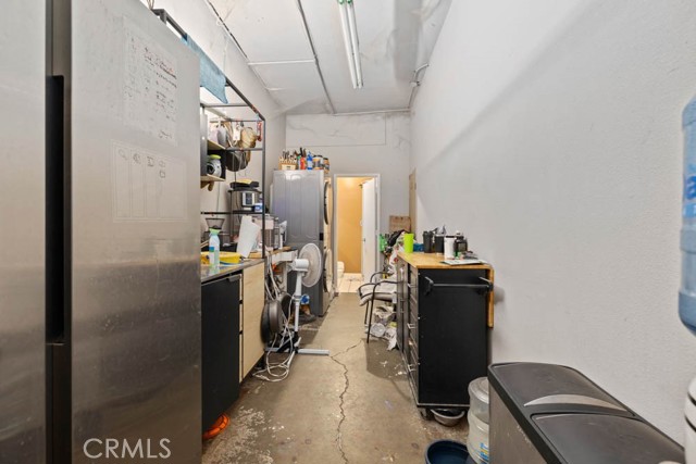 The back office space, double door entry and kitchenette.
