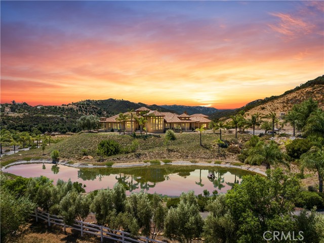 Priced dropped!Once in a lifetime opportunity with this awesome estate! Elegance and master craftsmanship define this exquisite 38.6-acre estate property with panoramic views and is located in the Safest City in Murrieta. This idyllic estate offers an exquisite blend of scenic beauty, equestrian elegance, and seamless balance.A rare property that Includes approximately 5 acres of vineyards, The barn houses 9 stalls for horses and additional housing for birds, or any other small farm animal desired. A pond adorns the approach to the main house and is landscaped beautifully. No HOA, 2 wells, and paid off solar.
The main home encompasses 4486 square feet with three bedrooms, Office, oversized laundry room, and a grand master bath with a round spa tub, walk-in shower, and dual sinks with vanity.
Another property has a 2-bedroom, 2-bath house and attic that was built in 2015 and is 1064 sq ft included in the overall square footage, It is a very independent and private living space.
The landlord spent over $1.5 million on the property, For example: building roads, planting vineyards, paying off solar energy, watering facilities, buying vehicles, and building lofts...... The current listing price includes all private property on the property, what you see, and what you get!(Except for some personal items )