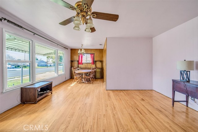 Living room leads to dining room with amazing front window for natural light!