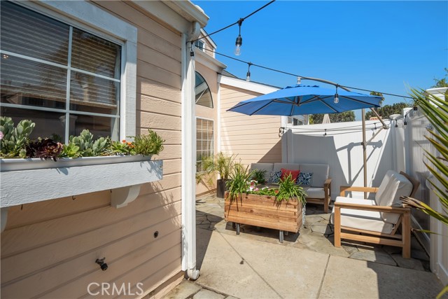 Room for BBQ, planted pots and sitting area in the private patio