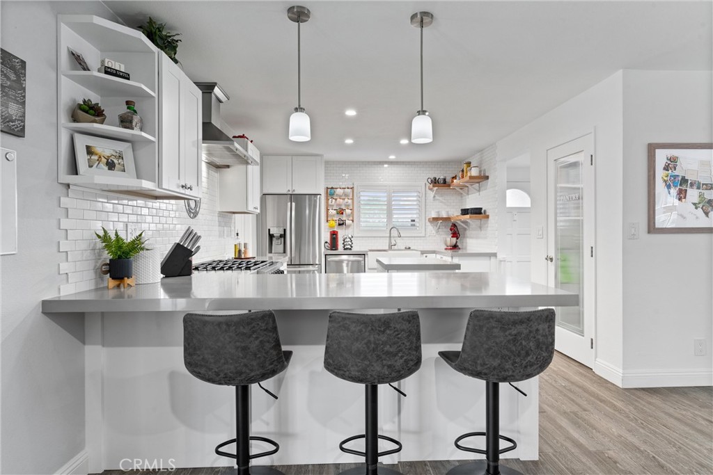 4971 Lemon Ave Cypress, California Welcome to this beautifully renovated single-level living space you’ve been looking to call home. Walk in to find tons of natural light, new tile and carpet flooring, contemporary-style fixtures, and recessed lighting throughout. The open-concept kitchen features a six-burner professional stove, fire-glazed farmhouse sink, white shaker cabinets, quartz countertops, a center mobile island, a kitchen peninsula, and a walk-in pantry. Down the hall, you’ll find three comfortably-sized bedrooms and a full bathroom that allows direct access to the large hot tub in the backyard. The primary suite features a barn door that leads to a completely upgraded bathroom with a walk-in shower. Enjoy entertaining outdoors in the spacious yard, or bring it indoors to the converted garage space that features built-in cabinets, a bar with a wine fridge, and a full bathroom. This home is perfectly nestled in a highly desirable area of Cypress, just steps away from great schools and parks. Come see for yourself how this home checks all the boxes!