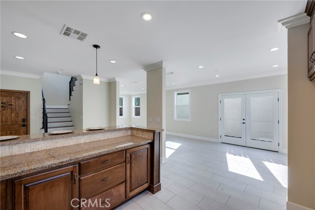 Dining area off kitchen has French doors to back patio.