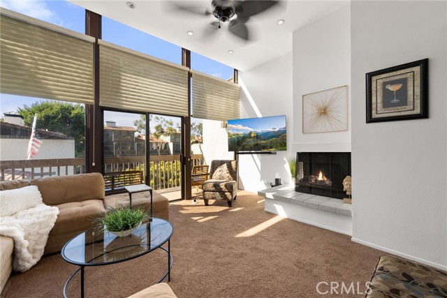 Views and high ceilings with a cozy fireplace.