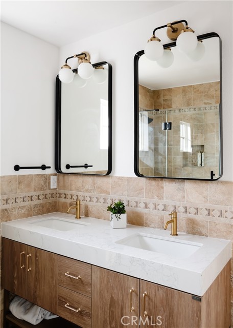 Secondary Bathroom features new cabinet, mirrors and plumbing fixtures