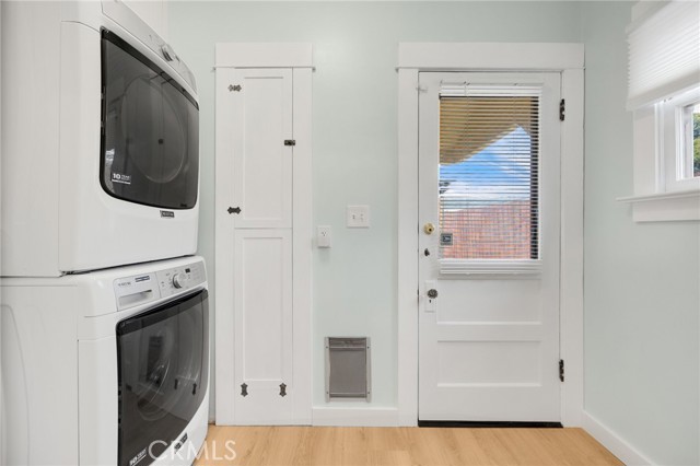 Utility room adjacent to kitchen with plentiful storage and laundry