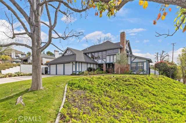 This must-see home is tucked away on a ½ acre lot in the heart of one of Yorba Linda’s highly sought-after estate neighborhoods! Secluded and surround by stately homes on a private street, the front yard overlooks part of Yorba Linda’s amazing trail system with split rail fence and gorgeous landscaping. The home is light and bright, and the original owners have lovingly cared for the home inside and out. The well-designed custom floor plan lends itself to a great living space with a large living room with fireplace, a formal dining room that is open to the yard, an opened beamed family room with fireplace, and a huge kitchen with spacious eating area, breakfast counter and pantry. The large downstairs bedroom includes a walk
in closet, window seat and a private 3/4 bath. The first level is complete with an additional powder room for guests and separate laundry room. The second story will impress with a loft with built-in storage and bookcases overlooking the entry and living room. The master bedroom with barrel/vaulted ceiling is a huge retreat with sitting area, walk-in closet, glorious bath with soaking tub, walk-in shower, dual vanities, and French doors that open to a fantastic balcony overlooking the trails and the neighborhood. Additionally, there are two large bedrooms to accommodate all. The yard features a large pool with spa, covered patio areas and tree top view. The oversized 3 car garage includes walk around overhead storage with a pull-down staircase, plus plenty of storage cabinets and a workbench. The home sits off street level and is a neighborhood standout! Walk to Yorba Linda High School or stroll a few blocks to the new bustling Towne Center via the trail system.