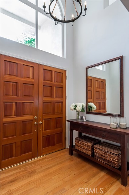 Large double doors open to a welcoming foyer/entry way