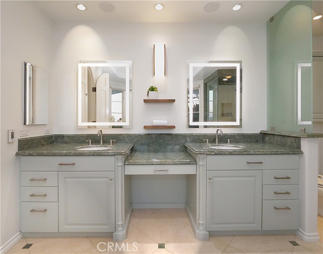 Primary ensuite with double sinks and granite counters