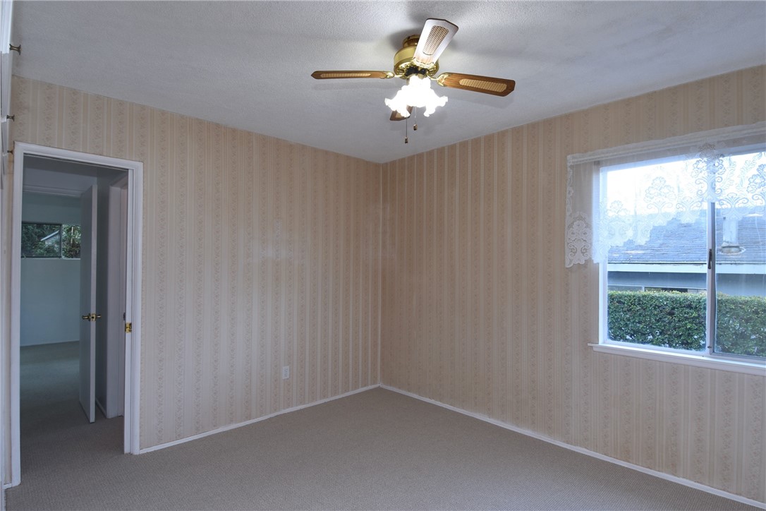 Bedroom #3 with bedroom #4 in the background.  There is a bathroom in between these rooms.  This room would be great for use as an office, gym, OR...these 2 rooms could be used as a separate 1 bedroom unit with it's own living room, bathroom, and separate entrance!