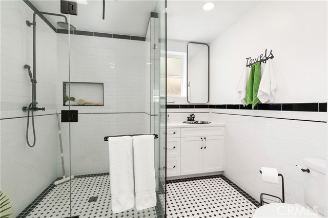 The primary bathroom. Custom tile floors and clean modern lines.