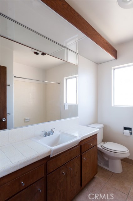 Full bath in hallway services upstairs bedrooms. Tile floors & new plumbing fixtures dress up the bathroom a little bit.