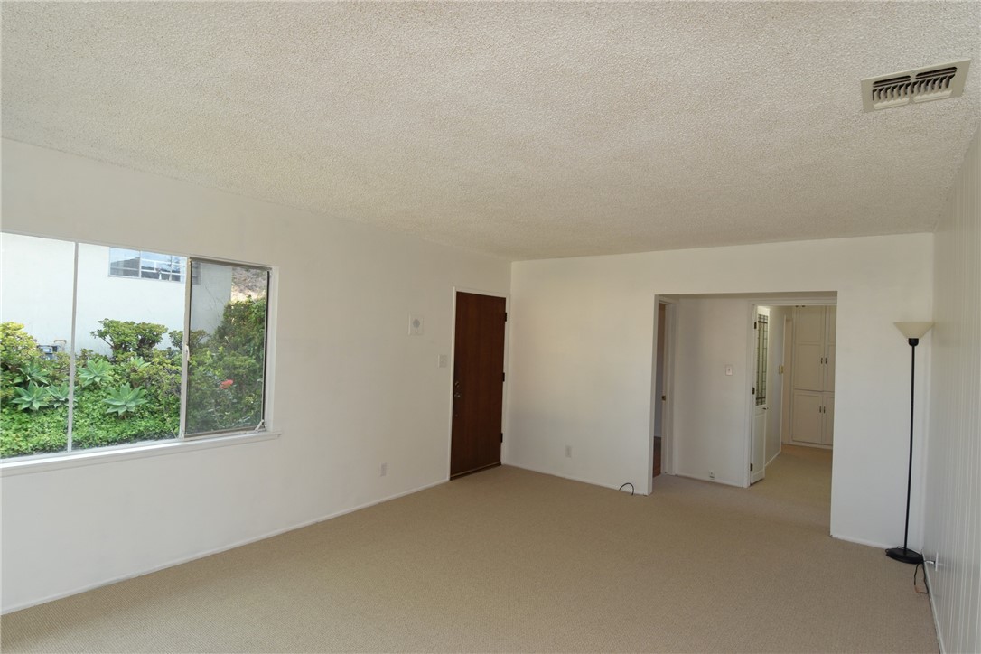 Another view of the living room with hallway leading to the bedrooms.