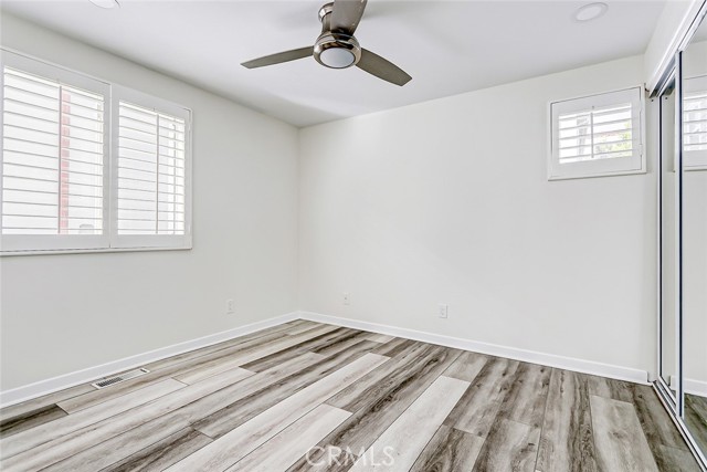 This bedroom is on the second level and includes plantation shutters and ceiling fan.