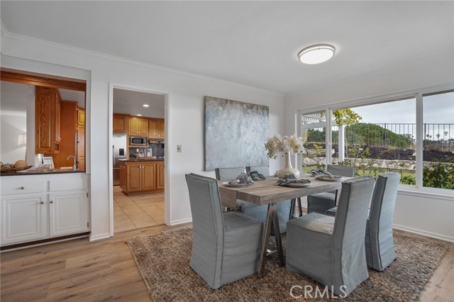 Formal dining room with ocean and sunset views, and a pass through bar to the kitchen.