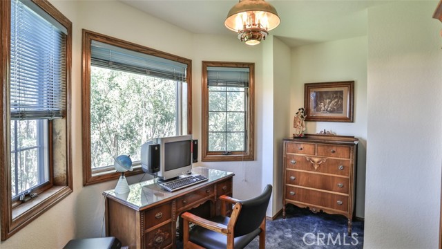 Office with windows to enjoy the outside off the primary bedroom