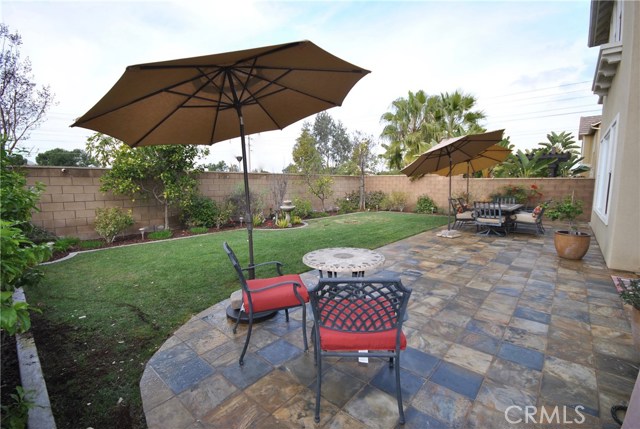 Large Professionally Landscaped Backyard with Mature Trees is Perfect for Relaxing on Sunny Days