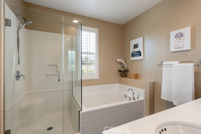 Primary bathroom offers separate soaking tub and shower
