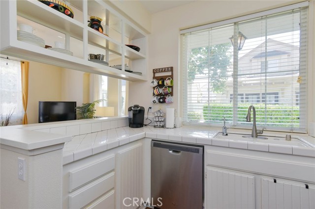 Nice kitchen with ample storage place and view of the neighborhood.